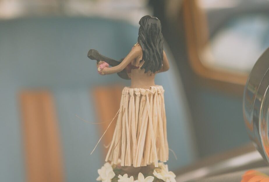 a small figurine of a woman holding a fan